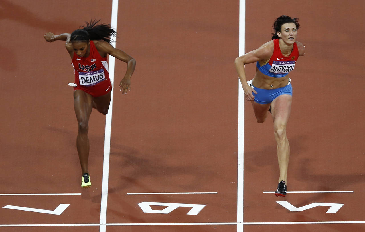 FILE - Russia's Natalya Antyukh, right, powers ahead of United States' Lashinda Demus to win gold i...