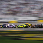 
              Daniel Suarez (99) leads the race at a restart during a NASCAR Cup Series auto race Sunday, Oct. 16, 2022, in Las Vegas. (AP Photo/John Locher)
            
