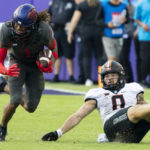 
              TCU wide receiver Quentin Johnston (1) runs with the ball in front of Oklahoma State linebacker Mason Cobb (0) during the second half of an NCAA college football game in Fort Worth, Texas, Saturday, Oct. 15, 2022. (AP Photo/Sam Hodde)
            