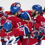 
              Montreal Canadiens' Josh Anderson (17) is congratulated by teammates after scoring against Toronto Maple Leafs goaltender Matt Murray during the third period of an NHL hockey game Wednesday, Oct. 12, 2022, in Montreal. (Paul Chiasson/The Canadian Press via AP)
            