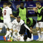 
              AC Milan's Rafael Leao celebrates with teammates after scoring his side's second goal during the Champions League Group E soccer match between Dinamo Zagreb and AC Milan in Zagreb, Croatia, Tuesday, Oct. 25, 2022. (AP Photo)
            