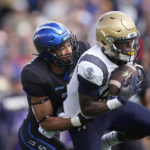 
              Navy wide receiver Mark Walker, right, pulls in a pass as Air Force cornerback Eian Castonguay covers in the second half of an NCAA college football game Saturday, Oct. 1, 2022, at Air Force Academy, Colo. (AP Photo/David Zalubowski)
            