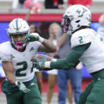 
              South Florida running back Brian Battie (21) takes a hand off from running back Michel Dukes (2) on a trick play against Houston during the first half of an NCAA college football game Saturday, Oct. 29, 2022, in Houston. (AP Photo/Michael Wyke)
            