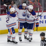 
              Edmonton Oilers center Connor McDavid, center, celebrates with defenseman Evan Bouchard, left, and center Ryan Nugent-Hopkins after scoring his goal during the third period of an NHL hockey game against the Chicago Blackhawks in Chicago, Thursday, Oct. 27, 2022. The Oilers won 6-5. (AP Photo/Nam Y. Huh)
            