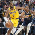 
              Los Angeles Lakers forward Troy Brown Jr., front, drives past Denver Nuggets forward Bruce Brown in the second half of an NBA basketball game Wednesday, Oct. 26, 2022, in Denver. (AP Photo/David Zalubowski)
            