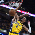 
              Indiana Pacers' Tyrese Haliburton (0) dunks against Washington Wizards' Anthony Gill during the second half of an NBA basketball game Wednesday, Oct. 19, 2022, in Indianapolis. (AP Photo/Michael Conroy)
            