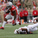 
              Ohio State running back Miyan Williams, left, leaps over Rutgers linebacker Deion Jennings during the first half of an NCAA college football game, Saturday, Oct. 1, 2022, in Columbus, Ohio. (AP Photo/Jay LaPrete)
            