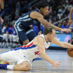 
              Detroit Pistons forward Bojan Bogdanovic and Memphis Grizzlies guard Kennedy Chandler chase the loose ball during the second half of an NBA preseason basketball game, Thursday, Oct. 13, 2022, in Detroit. (AP Photo/Carlos Osorio)
            