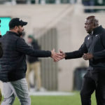 
              Ohio State coach Ryan Day, left, and Michigan State coach Mel Tucker shake hands after an NCAA college football game Saturday, Oct. 8, 2022, in East Lansing, Mich. (AP Photo/Carlos Osorio)
            