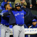 
              Toronto Blue Jays' Vladimir Guerrero Jr., right, celebrates near the dugout with Teoscar Hernandez after hitting a solo home run against the Baltimore Orioles during the third inning of a baseball game, Monday, Oct. 3, 2022, in Baltimore. (AP Photo/Julio Cortez)
            