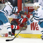 
              San Jose Sharks center Luke Kunin (11) check New Jersey Devils center Yegor Sharangovich (17) into the boards during the first period of an NHL hockey game, Saturday, Oct. 22, 2022, in Newark, N.J. (AP Photo/Noah K. Murray)
            
