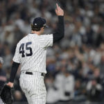 
              New York Yankees starting pitcher Gerrit Cole (45) motions to fans as he walks off the field during Game 1 of an American League Division baseball series against the Cleveland Guardians, Tuesday, Oct. 11, 2022, in New York. (AP Photo/John Minchillo)
            