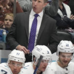 
              Seattle Kraken coach Dave Hakstol talks to players during the second period of the team's NHL hockey game against the Colorado Avalanche on Friday, Oct. 21, 2022, in Denver. (AP Photo/David Zalubowski)
            