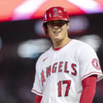 
              Los Angeles Angels designated hitter Shohei Ohtani smiles while at third base during the first inning of the team's baseball game against the Texas Rangers in Anaheim, Calif., Friday, Sept. 30, 2022. (AP Photo/Alex Gallardo)
            