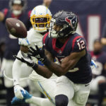 
              Houston Texans wide receiver Nico Collins (12) pulls in a catch in front of Los Angeles Chargers cornerback J.C. Jackson (27) during the second half of an NFL football game Sunday, Oct. 2, 2022, in Houston. (AP Photo/David J. Phillip)
            