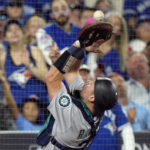 
              Seattle Mariners catcher Cal Raleigh catches a popup from Toronto Blue Jays' Alejandro Kirk during the sixth inning of Game 1 in an AL wild-card baseball playoff series in Toronto on Friday, Oct. 7, 2022. (Frank Gunn/The Canadian Press via AP)
            