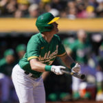 
              Oakland Athletics' Conner Capel watches his sacrifice fly against the Los Angeles Angels during the fifth inning of a baseball game in Oakland, Calif., Wednesday, Oct. 5, 2022. Stephen Vogt scored from third on the play. (AP Photo/Godofredo A. Vásquez)
            