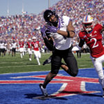 
              TCU wide receiver Quentin Johnston (1) catches the game-winning touchdown under pressure from Kansas cornerback Cobee Bryant during the second half of an NCAA college football game Saturday, Oct. 8, 2022, in Lawrence, Kan. TCU won 38-31. (AP Photo/Charlie Riedel)
            