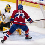 
              Montreal Canadiens' Kirby Dach (77) scores the winning goal past Pittsburgh Penguins goaltender Casey DeSmith during overtime NHL hockey game action in Montreal, Monday, Oct. 17, 2022. (Paul Chiasson/The Canadian Press via AP
            