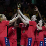 
              Gold medalists the United States hold their trophy aloft as they celebrate on the podium after defeating China in the final at the women's Basketball World Cup in Sydney, Australia, Saturday, Oct. 1, 2022. (AP Photo/Mark Baker)
            