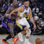 
              Golden State Warriors guard Stephen Curry (30) gets around Los Angeles Lakers guard Lonnie Walker IV (4) during the first half of an NBA basketball game in San Francisco, Tuesday, Oct. 18, 2022. (AP Photo/Godofredo A. Vásquez)
            