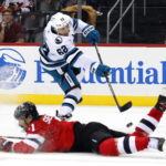 
              San Jose Sharks right wing Kevin Labanc (62) scores a goal past New Jersey Devils defenseman Jonas Siegenthaler (71) during the second period of an NHL hockey game, Saturday, Oct. 22, 2022 in Newark, N.J. (AP Photo/Noah K. Murray)
            