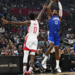 
              LA Clippers forward Paul George (13) shoots against Houston Rockets forward Tari Eason (17) during the first half of an NBA basketball game in Los Angeles, Monday, Oct. 31, 2022. (AP Photo/Ashley Landis)
            