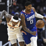 
              Phoenix Suns center Jock Landale, left, bumps into Los Angeles Clippers guard Paul George during the second half of an NBA basketball game, Sunday, Oct. 23, 2022, in Los Angeles. (AP Photo/Alex Gallardo)
            