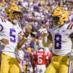 
              LSU quarterback Jayden Daniels (5) celebrates a touchdown with wide receiver Malik Nabers (8) during the first half of an NCAA college football game against Mississippi in Baton Rouge, La., Saturday, Oct. 22, 2022. (AP Photo/Matthew Hinton)
            