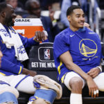 
              Golden State Warriors forward Draymond Green, left, and guard Jordan Poole (3) sit on the bench during the first half of the team's NBA preseason basketball game against the Denver Nuggets in San Francisco, Friday, Oct. 14, 2022. (Santiago Mejia/San Francisco Chronicle via AP)
            