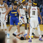 
              Golden State Warriors guard Stephen Curry, bottom, is congratulated by guard Klay Thompson (11) after scoring against the Denver Nuggets during the first half of an NBA basketball game in San Francisco, Friday, Oct. 21, 2022. (AP Photo/Jeff Chiu)
            