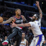 
              Portland Trail Blazers guard Damian Lillard, left, passes the ball away from Los Angeles Lakers forward Anthony Davis during the second half of an NBA basketball game Sunday, Oct. 23, 2022, in Los Angeles. (AP Photo/Alex Gallardo)
            