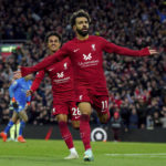 
              Liverpool's Mohamed Salah celebrates after scoring his side's opening goal during the English Premier League soccer match between Liverpool and Manchester City at Anfield stadium in Liverpool, Sunday, Oct. 16, 2022. 
 (Peter Byrne/PA via AP)
            