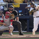 
              San Diego Padres' Austin Nola hits an RBI-single during the fifth inning in Game 2 of the baseball NL Championship Series between the San Diego Padres and the Philadelphia Phillies on Wednesday, Oct. 19, 2022, in San Diego. (AP Photo/Ashley Landis)
            