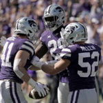 
              Kansas State linebacker Austin Moore (41) celebrates with linebackers Khalid Duke (29) and Nick Allen (52) after intercepting a pass during the first half of an NCAA college football game against Texas Tech Saturday, Oct. 1, 2022, in Manhattan, Kan. (AP Photo/Charlie Riedel)
            
