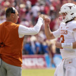 
              Texas quarterback Quinn Ewers (3) is congratulated by head coach Steve Sarkisian after a touchdown during the second half of an NCAA college football game against Oklahoma at the Cotton Bowl, Saturday, Oct. 8, 2022, in Dallas. Texas won 49-0. (AP Photo/Jeffrey McWhorter)
            