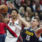 
              Portland Trail Blazers guard Anfernee Simons, left, shoots over Denver Nuggets center Nikola Jokic during the second half of an NBA basketball game in Portland, Ore., Monday, Oct. 24, 2022. (AP Photo/Craig Mitchelldyer)
            