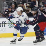 
              Tampa Bay Lightning's Brayden Point, left, and Columbus Blue Jackets' Vladislav Gavrikov chase the puck during the first period of an NHL hockey game Friday, Oct. 14, 2022, in Columbus, Ohio. (AP Photo/Jay LaPrete)
            