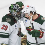 
              Minnesota Wild's goaltender Marc-Andre Fleury is congratulated by teammate Brandon Duhaime (21) after defeating the Montreal Canadiens in an NHL hockey game in Montreal, Tuesday, Oct. 25, 2022. (Graham Hughes/The Canadian Press via AP)
            