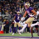SEATTLE, WASHINGTON - NOVEMBER 19: Wayne Taulapapa #21 of the Washington Huskies scores a touchdown during the first quarter against the Colorado Buffaloes at Husky Stadium on November 19, 2022 in Seattle, Washington. (Photo by Steph Chambers/Getty Images)