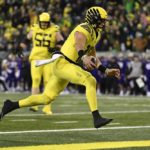 Oregon quarterback Bo Nix (10) scores against Washington during the first half of an NCAA college football game Saturday, Nov. 12, 2022, in Eugene, Ore. (AP Photo/Andy Nelson)
