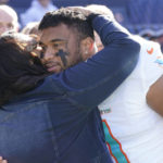 
              Miami Dolphins quarterback Tua Tagovailoa gets a hug from his mother Diane Tagovailoa before the start of an NFL football game against the Chicago Bears, Sunday, Nov. 6, 2022 in Chicago. (AP Photo/Charles Rex Arbogast)
            