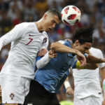 
              FILE - Portugal's Cristiano Ronaldo and Uruguay's Edinson Cavani challenge for the ball during the round of 16 match between Uruguay and Portugal at the 2018 soccer World Cup at the Fisht Stadium in Sochi, Russia, Saturday, June 30, 2018. (AP Photo/Francisco Seco, File)
            