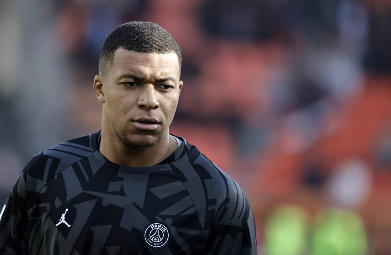 PSG's Kylian Mbappe looks on during warm up before the French League One soccer match between FC Lo...