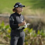 
              Hinako Shibuno, of Japan, checks her course notes before hitting her second shot on the ninth fairway during the second round of the LPGA CME Group Tour Championship golf tournament, Friday, Nov. 18, 2022, at the Tiburón Golf Club in Naples, Fla. (AP Photo/Lynne Sladky)
            