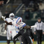 
              Tulane defensive back Lance Robinson (7) breaks up a pass intended for Southern Methodist wide receiver Rashee Rice (11) during the first half of an NCAA college football game in New Orleans, Thursday, Nov. 17, 2022. (AP Photo/Gerald Herbert)
            