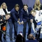 
              Former Winnipeg Jets' Teppo Numminen, center right, and Teemu Selanne,  center left, prepare to drop the puck during a ceremony where they were inducted into the Winnipeg Jets Hall of Fame prior to an NHL game against the Anaheim Ducks in Winnipeg, Manitoba, Thursday, Nov. 17, 2022. (John Woods/The Canadian Press via AP)
            