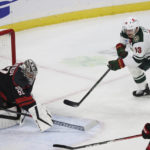 
              Minnesota Wild center Sam Steel (13) watches the puck after Carolina Hurricanes goaltender Pyotr Kochetkov (52) turned away his shot during the second period of an NHL hockey game Saturday, Nov. 19, 2022, in St. Paul, Minn. (AP Photo/Stacy Bengs)
            