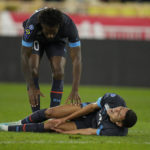 
              Marseille's Amine Harit lies on the pitch in pain during the French League One soccer match between Monaco and Marseille at the Stade Louis II in Monaco, Sunday, Nov. 13, 2022. (AP Photo/Daniel Cole)
            