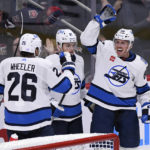 
              Winnipeg Jets' Nate Schmidt (88) celebrates his goal against the Chicago Blackhawks with Blake Wheeler (26) and Cole Perfetti (91) during the third period of an NHL hockey game in Winnipeg, Manitoba, Saturday, Nov. 5, 2022. (Fred Greenslade/The Canadian Press via AP)
            
